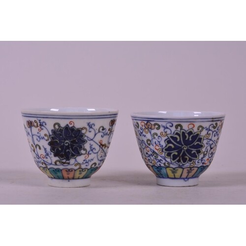 A pair of Chinese doucai porcelain tea bowls with lotus flow...