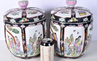A pair of Chinese porcelain polychrome lidded jars decorated with figures in panels 28cm (2).