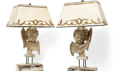 A pair of French carved wood cherub lamps, 20th century, each with traces of paint, on wood bases, 45cm high excluding fitment (2) (It is the buyer's responsibility to ensure that electrical items are professionally rewired for use)