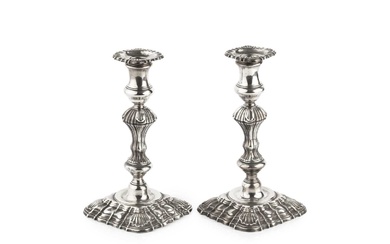 A pair of George II silver candlesticks, with shaped and...