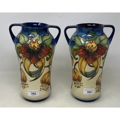 A pair of Moorcroft pottery vases, decorated flowers, with t...