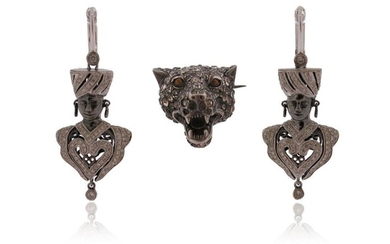 A pair of diamond-set gold blackamoor earrings, set in white...