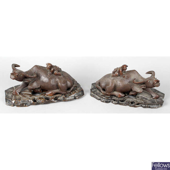 A pair of early 20th century Chinese carved hardwood studies of water buffalo.