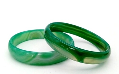A pair of high quality, green, banded, agate bangles, in ori...