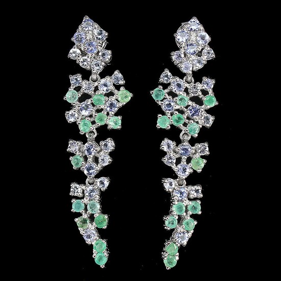 NOT SOLD. A pair of tanzanite and emerald ear pendants each set with numerous circular-cut...