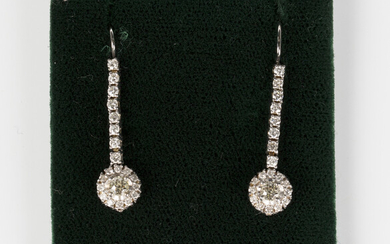 A pair of white gold and diamond pendant earrings, each claw set with a row of circular cut diamonds