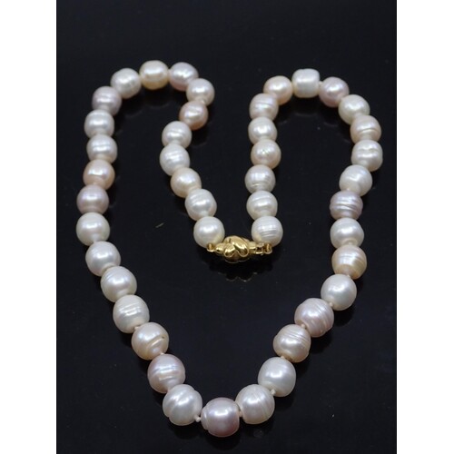 A pearl necklace with a gold clasp