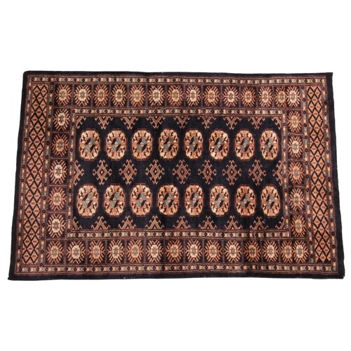 * A small hand woven bokhara wool carpet, of typical design,...
