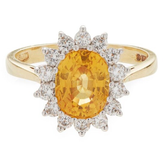 A yellow sapphire and diamond set cluster ring claw set...