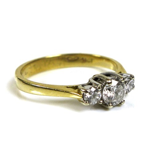 An 18ct gold and diamond three stone ring, the central stone...