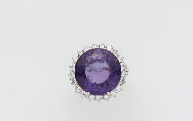 An 18k gold diamond and amethyst cluster ring.