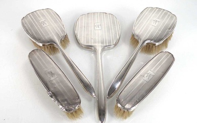 An early 20th century engine turned silver five piece dressing...