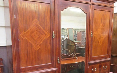 An early 20th century mahogany inlaid compactum having a bevel...