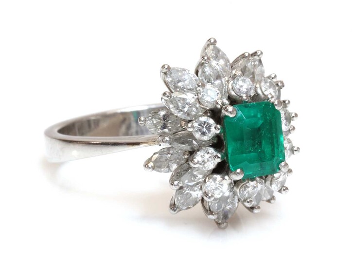 An emerald and diamond three tier cluster ring