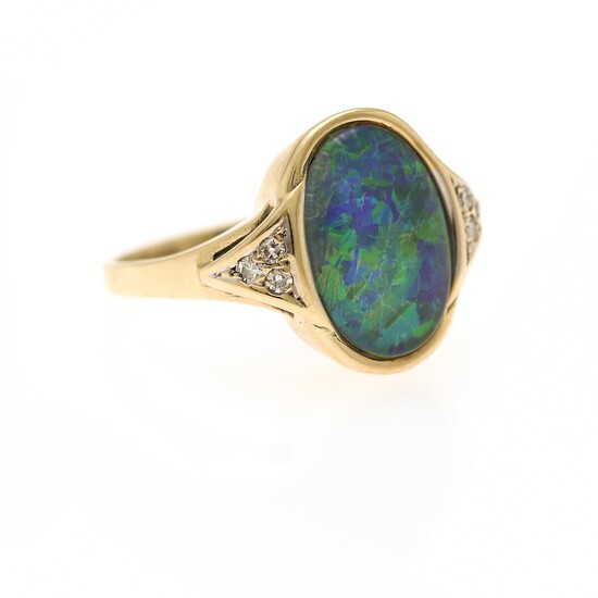 An opal and diamond ring set with a cabochon opal flanked by six single-cut diamonds, mounted in 14k gold. Size app. 53.