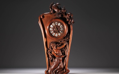 Art Nouveau clock in carved walnut with a half-dressed lady...
