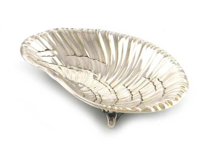By Tiffany and Co. an American silver dish, Edward Moore period, modelled as an oyster, on three scroll bracket feet, length 15.2cm, approx. weight 3.5oz.