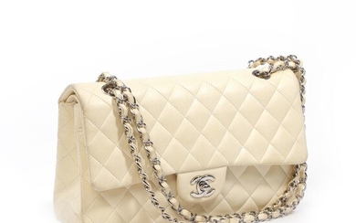 Chanel A “Classic Double Flap” bag of creme coloured quilted leather with...