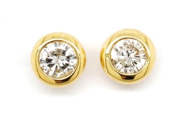 Diamond and 18ct yellow gold stud earrings in a bezel settin...