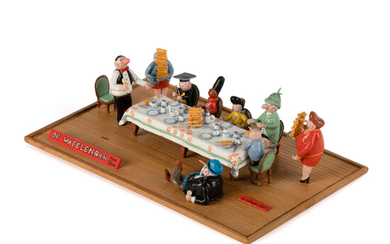 Diorama van de Wafelenbak, met een scène waarbij de hoofdfiguren aan tafel zitten en mevrouw Nero en mevrouw Pheip de wa