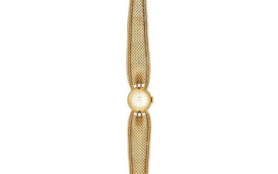 GUBELIN, A VINTAGE LADIES' WRISTWATCH in 18ct yellow gold, silver dial with gold baton hour marke...