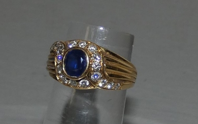 Jauen gold ring centered with an oval sapphire...