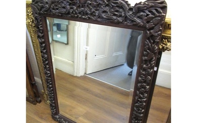 Large Chinese carved hardwood wall mirror, decorated with dr...