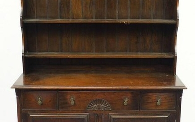 Oak dresser with open plate rack above three drawers