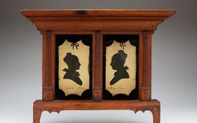 PAIR OF HOLLOW-CUT SILHOUETTES OF THE STONE SISTERS IN AN ARCHITECTURAL FRAME.