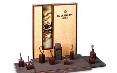 Patek Philippe. An Attractive Wood and Leatherette Platform with Nine Watch Display Stands