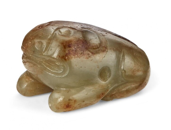 Property of a Gentleman (lots 36-85) A Chinese green and russet jade 'tiger' bead, 16th century, carved as a stylised crouching tiger, 3cm long