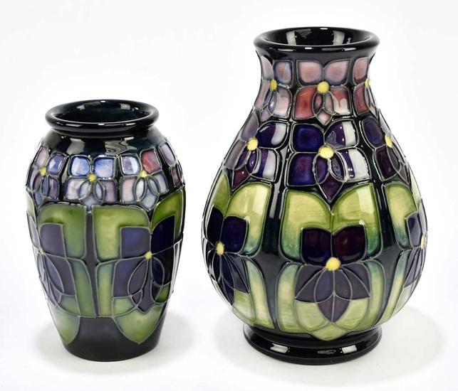 SALLY TUFFIN FOR MOORCROFT; two vases decorated in the 'Violet'...