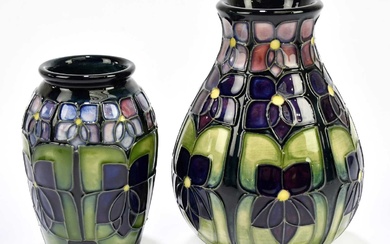 SALLY TUFFIN FOR MOORCROFT; two vases decorated in the 'Violet'...