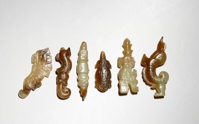 SIX SMALL CHINESE ARCHAISTIC CELADON AND RUSSET JADE PENDANTS PROBABLY...
