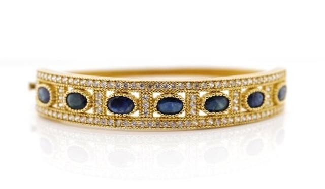 Sapphire and 14ct yellow gold hinged bangle with a cubic zir...