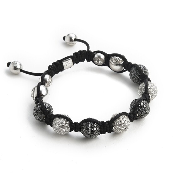 Shamballa: A diamond bracelet set with numerous brilliant-cut black and white diamonds weighing a total of app. 13.00 ct., mounted in 18k white gold.