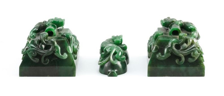 THREE CHINESE GREEN JADE SEALS All with qilin finials. Two square, 3" x 3", and one in gourd form, length 3".