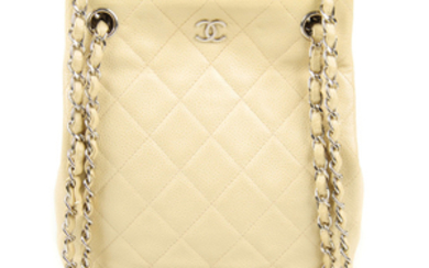 CHANEL - a small beige Caviar handbag.