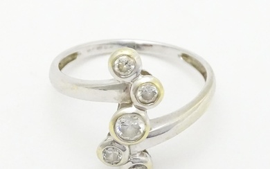 A 14ct white gold ring set with five white stones. Ring size...