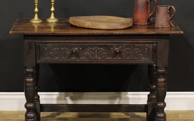 A 17th century oak side table, oversailing top above a long ...