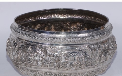 A Burmese silver circular bowl, profusely chased with figure...