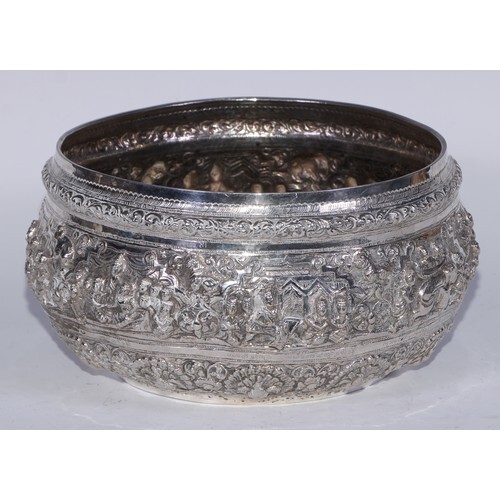 A Burmese silver circular bowl, profusely chased with figure...