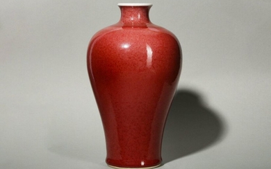 A CHINESE COPPER RED-GLAZED VASE, MEIPING. Qing Dynasty. The high shouldered body tapering to a slightly flared foot supporting a short waisted neck, covered overall in a rich red glaze, pooling to a deeper tone at the foot, the base incised with a...