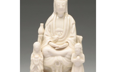 A Chinese blanc de chine figure of Guanyin with two children...