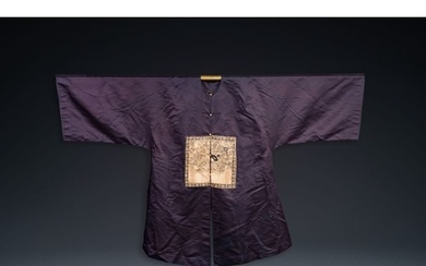 A Chinese dark blue silk overcoat with gold thread embroider...
