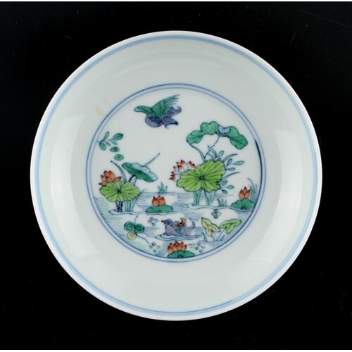 A Chinese doucai saucer dish painted with a pond scene, unde...