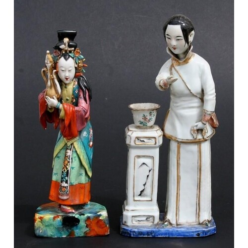 A Chinese glazed pottery figure of a robed lady standing nex...