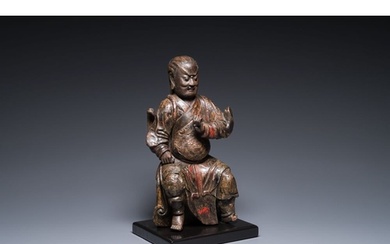 A Chinese lacquered and polychromed wood sculpture of a Budd...