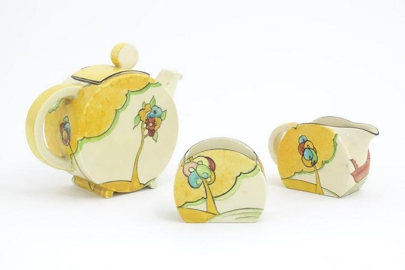 A Clarice Cliff tea set decorated in the Moonlight pattern comprising teapot, sugar bowl and milk