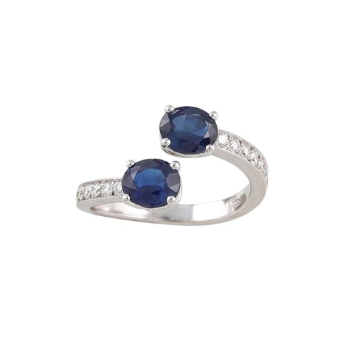 A DIAMOND AND SAPPHIRE RING, of cross over design, set with ...